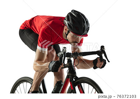 Young professional male bike rider on road bike isolated over white background. Young professional male bike rider on road bike isolated over white background. 76372103