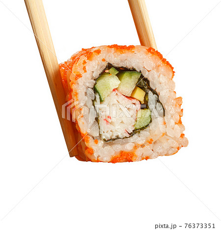 Two chopsticks holding Uramaki California sushi roll Two chopsticks holding Uramaki California sushi roll 76373351