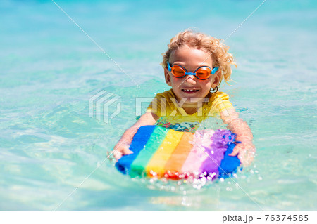 Kids playing on beach. Children play at sea. Kids playing on beach. Children play at sea. 76374585