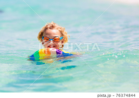Kids playing on beach. Children play at sea. Kids playing on beach. Children play at sea. 76374844