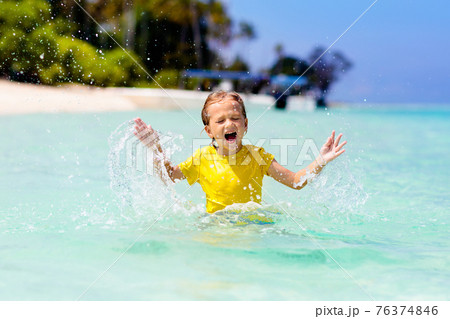 Kids playing on beach. Children play at sea. Kids playing on beach. Children play at sea. 76374846