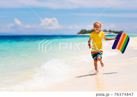 Kids playing on beach. Children play at sea. Kids playing on beach. Children play at sea. 76374847