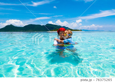 Mother and kid at tropical beach. Family vacation. Mother and kid at tropical beach. Family vacation. 76375265