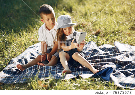 Cute little girl playing in a park with her friend 76375678