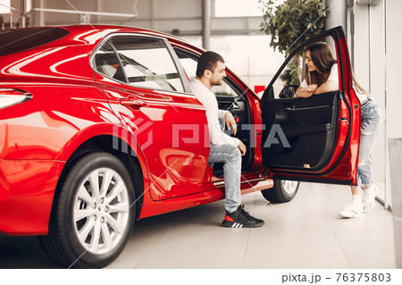 Stylish and elegant family in a car salon 76375803