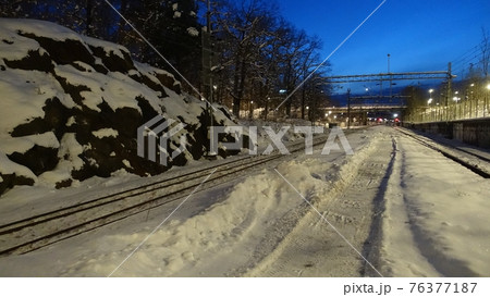 A perspective of the rails of a train station at dawn in northern Europe A perspective of the rails of a train station at dawn in northern Europe 76377187