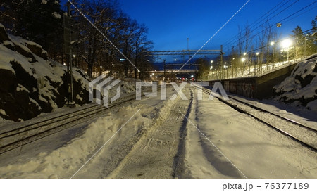 A perspective of the rails of a train station at dawn in northern Europe A perspective of the rails of a train station at dawn in northern Europe 76377189