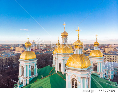 Aerial top view to St. Nicholas Naval Sea Cathedral in sunny day. Panorama of evening historical city center. Orthodox church located on banks of Kryukov and Griboyedov canal. Saint Petersburg. Russia 76377469