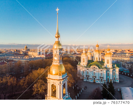 Aerial top view to St. Nicholas Naval Sea Cathedral in sunny day. Panorama of evening historical city center. Orthodox church located on banks of Kryukov and Griboyedov canal. Saint Petersburg. Russia 76377470