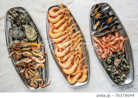 mixed fresh seafood selection gourmet set platter meal on table 76378044
