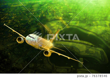 Plane is flying over green area against sunset. Plane is flying over green area against sunset. 76378546