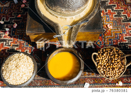 ARGAN OIL. Making of argan oil from argan nuts and seeds in Morocco 76380381