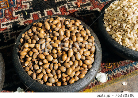 ARGAN SEEDS AND ARGAN NUTS. Making of argan oil from argan nuts and seeds in Morocco ARGAN SEEDS AND ARGAN NUTS. Making of argan oil from argan nuts and seeds in Morocco 76380386