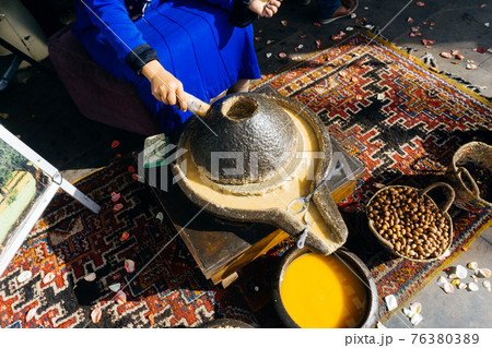 ARGAN OIL. Making of argan oil from argan nuts and seeds in Morocco 76380389