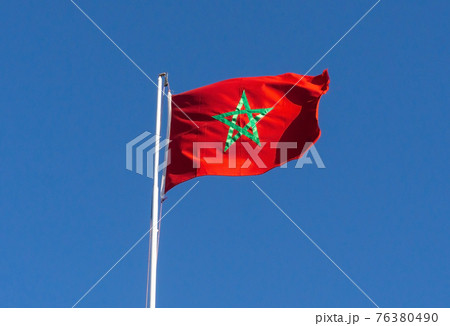 Real flag of morocco on blue sky background Real flag of morocco on blue sky background 76380490