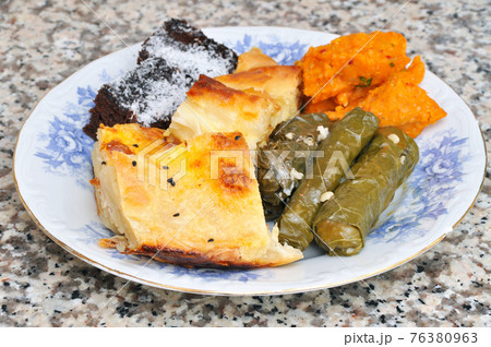 Snack Turkish pastry, cocoa cake, stuffed, on granite in plate Snack Turkish pastry, cocoa cake, stuffed, on granite in plate 76380963