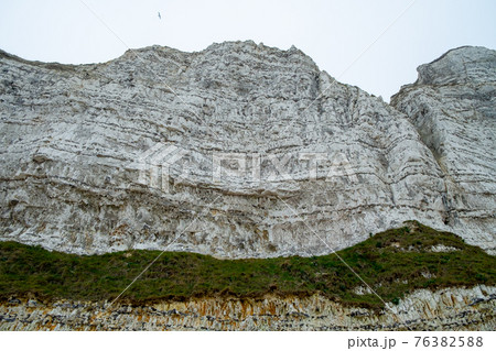 Misty morning fog landscape on the cliffs of Etretat in France 76382588