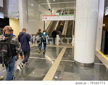 Large comfortable fast metal modern escalators with automatic steps for going up and down the subway or shopping and entertainment center Large comfortable fast metal modern escalators with automatic steps for going up and down the subway or shopping and entertainment center 76382773