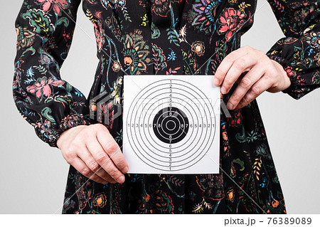 Woman with paper target in hands. Health, menopause, hygiene and well-being concept 76389089