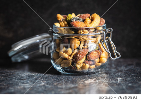 Mix of salted nuts in jar. 76390893