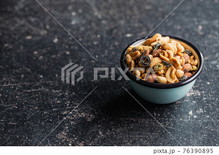 Mix of salted nuts in bowl. Mix of salted nuts in bowl. 76390895