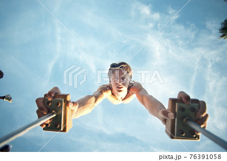 Caucasian man doing handstand 76391058