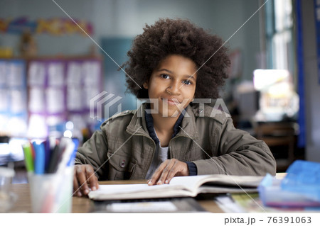African American boy studying in classroom African American boy studying in classroom 76391063