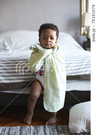African American boy wrapped in blanket 76391079
