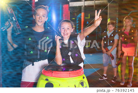 Boy and girl with laser guns Boy and girl with laser guns 76392145