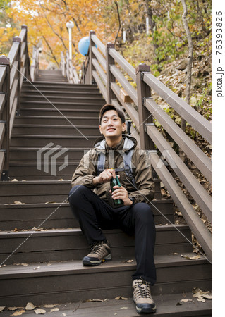 Asian handsome man trekking, climbing autumn mountain Asian handsome man trekking, climbing autumn mountain 76393826