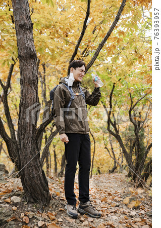 Asian handsome man with mask trekking, climbing autumn mountain Asian handsome man with mask trekking, climbing autumn mountain 76393957