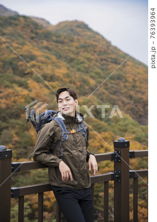 Asian handsome man trekking, climbing autumn mountain Asian handsome man trekking, climbing autumn mountain 76393964