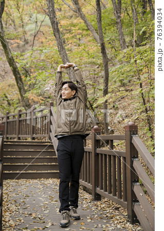 Asian handsome man trekking, climbing autumn mountain Asian handsome man trekking, climbing autumn mountain 76394034