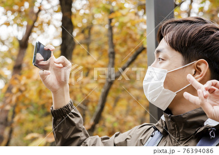Asian handsome man with mask trekking, climbing autumn mountain Asian handsome man with mask trekking, climbing autumn mountain 76394086