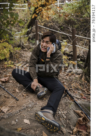 Asian handsome man trekking, climbing autumn mountain Asian handsome man trekking, climbing autumn mountain 76394117