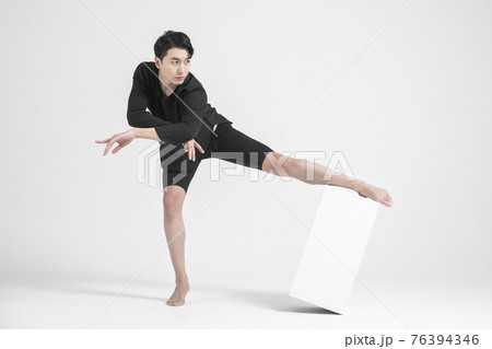 contemporary asian male dancer making move in white background 76394346