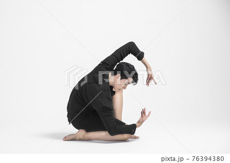 contemporary asian male dancer making move in white background 76394380