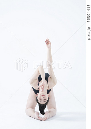 contemporary Asian female dancer making move in white background 76394413