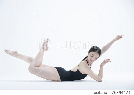 contemporary Asian female dancer making move in white background 76394421