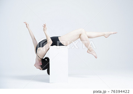 contemporary Asian female dancer making move in white background 76394422