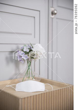 mask on table with flowers mask on table with flowers 76395092