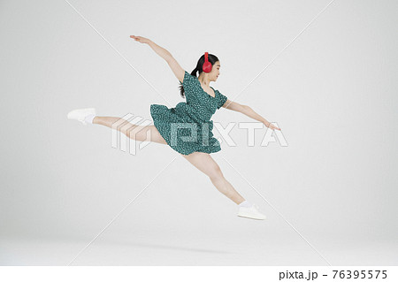 Asian female contemporary dancer making move with headset Asian female contemporary dancer making move with headset 76395575