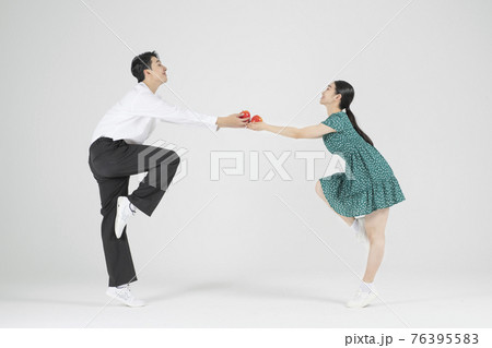 Asian couple contemporary dancers holding apple Asian couple contemporary dancers holding apple 76395583