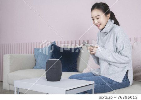 Asian single solo woman living alone concept using artificial intelligence speaker 76396015