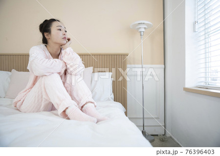 sick Asian woman in bed 76396403