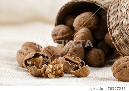 walnuts in woven basket 76397235