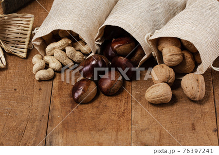 chestnuts, peanuts and walnuts in woven bags chestnuts, peanuts and walnuts in woven bags 76397241