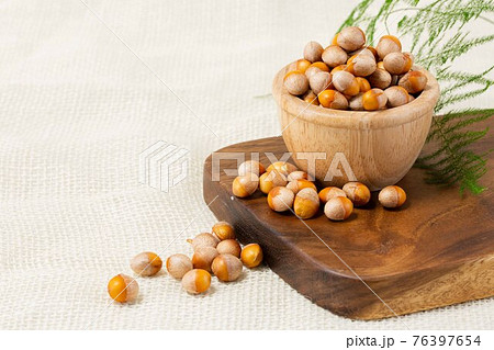 ginkgo nuts in wood bowl 76397654