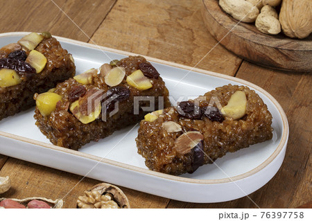 Yakbap, Korean dessert flavored glutinous rice mixed with honey, dates, chestnuts Yakbap, Korean dessert flavored glutinous rice mixed with honey, dates, chestnuts 76397758