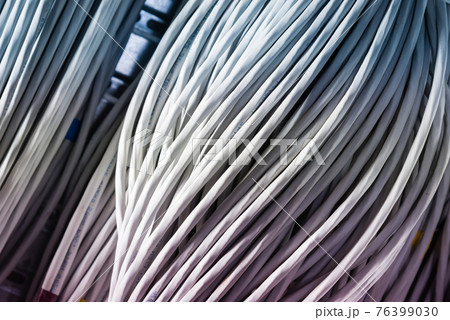 bunch of network cables in wave pattern leading across server ro bunch of network cables in wave pattern leading across server ro 76399030